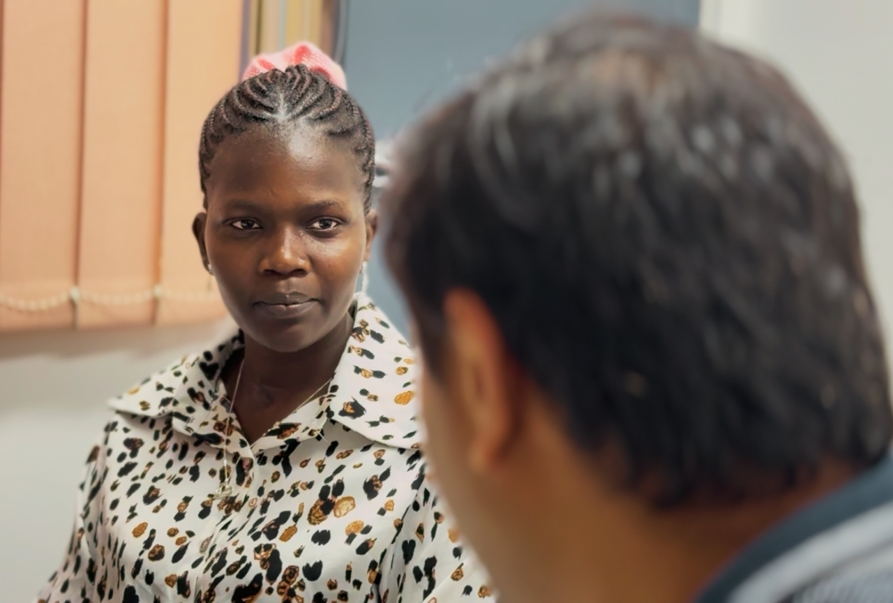 Akol in conversation with her caseworker at the Mosaic Multicultural Connections office, Armidale