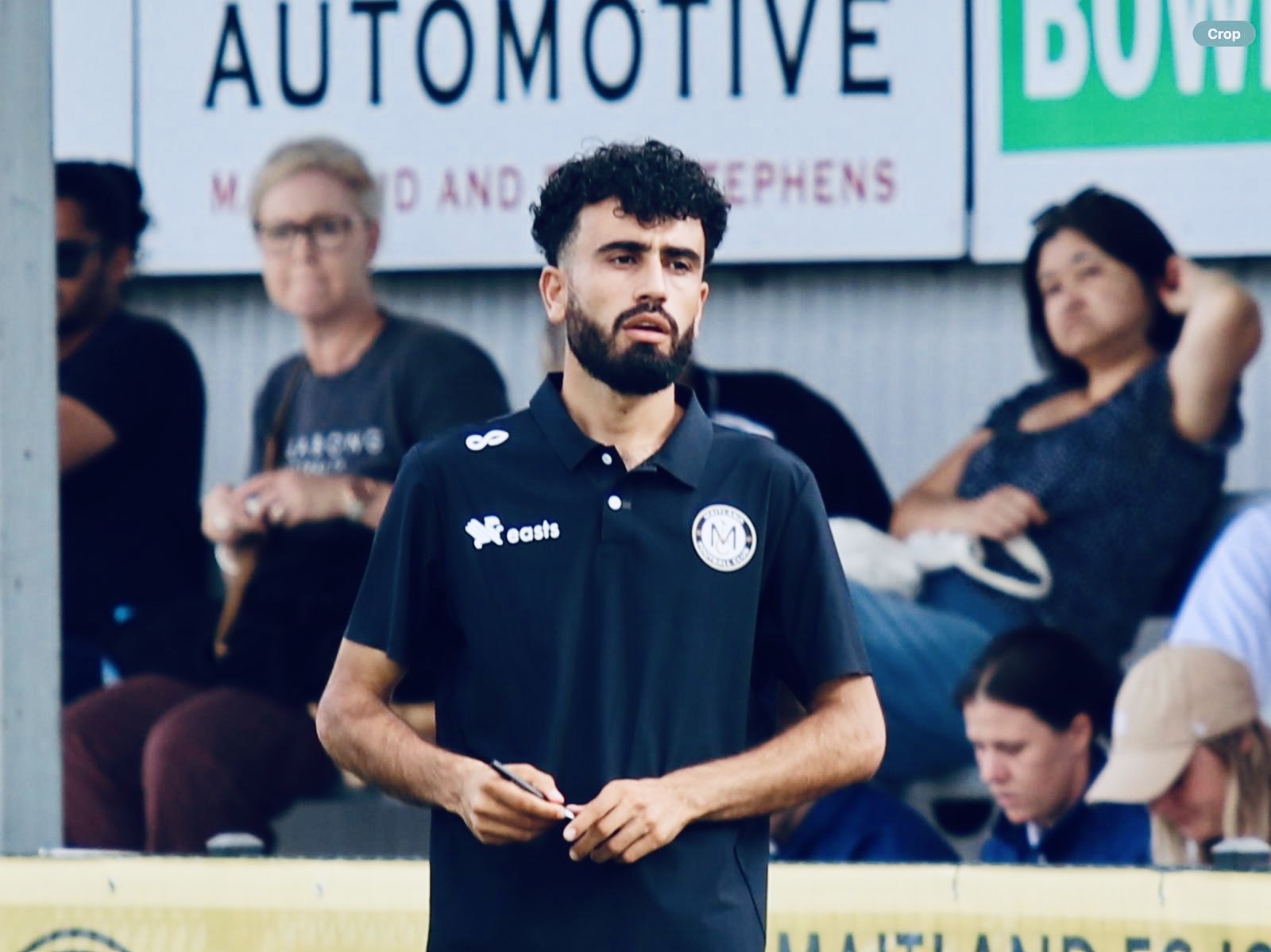 Mustafa Mohmand "Zac" standing on the football pitch sideline