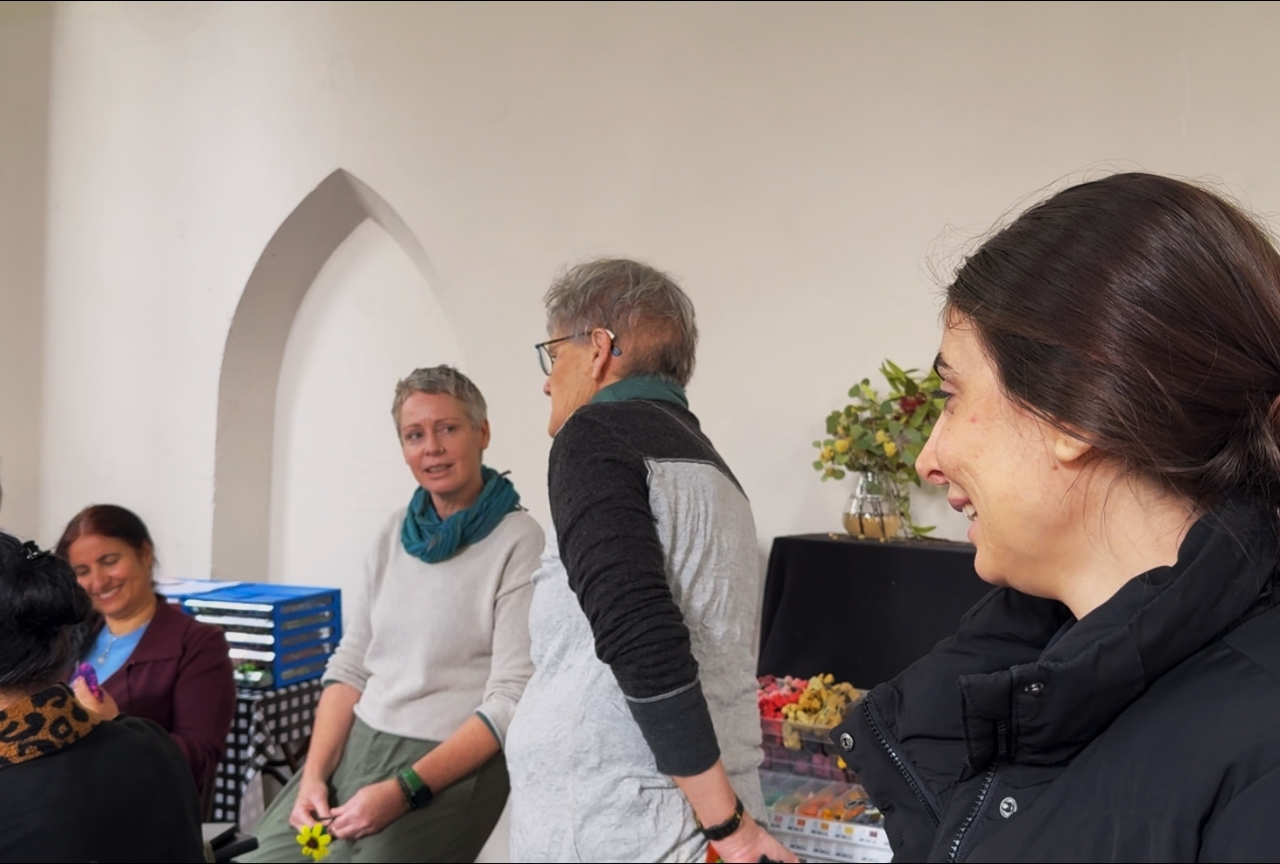 Orien (right foreground, smiling) with other women in conversation at Thread Shed, Newcastle